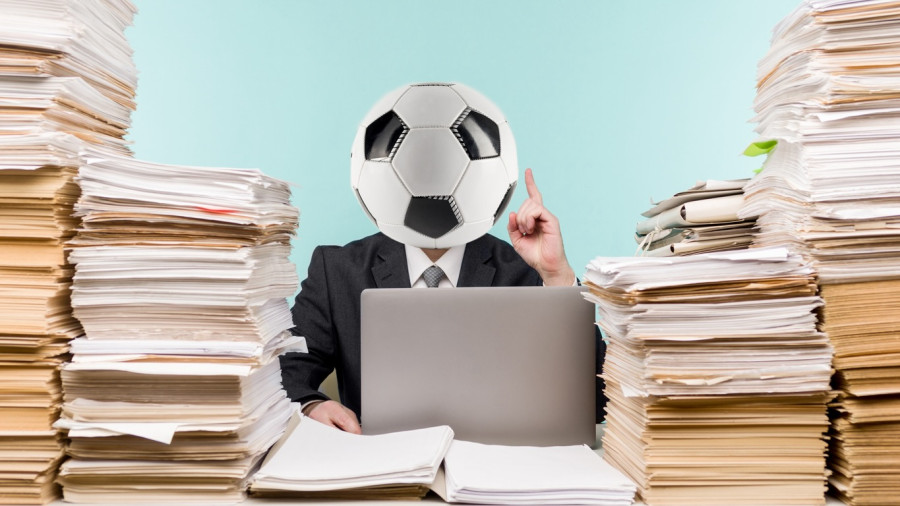 accountant with football on head