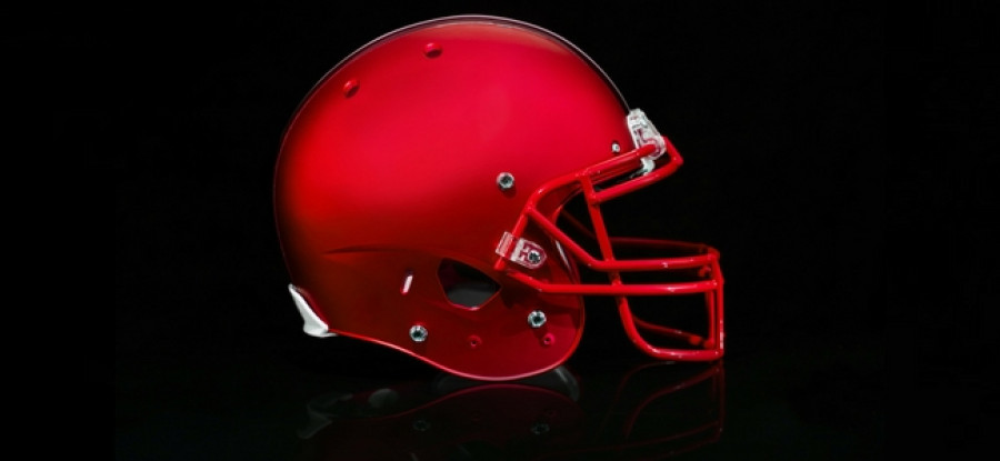 A sideview of a red american football helmet 