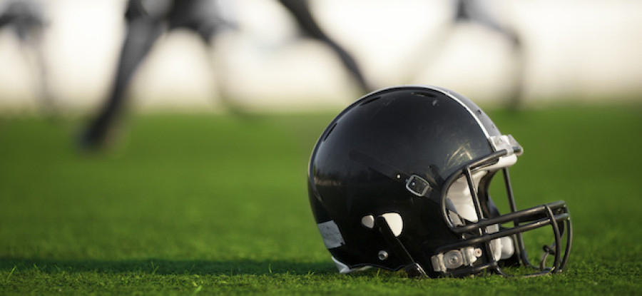 American football helmet on grass 