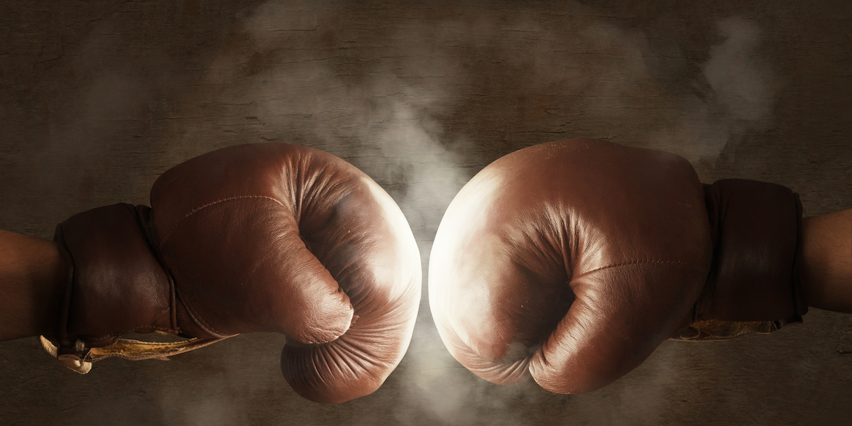 Brown boxing gloves hitting each other