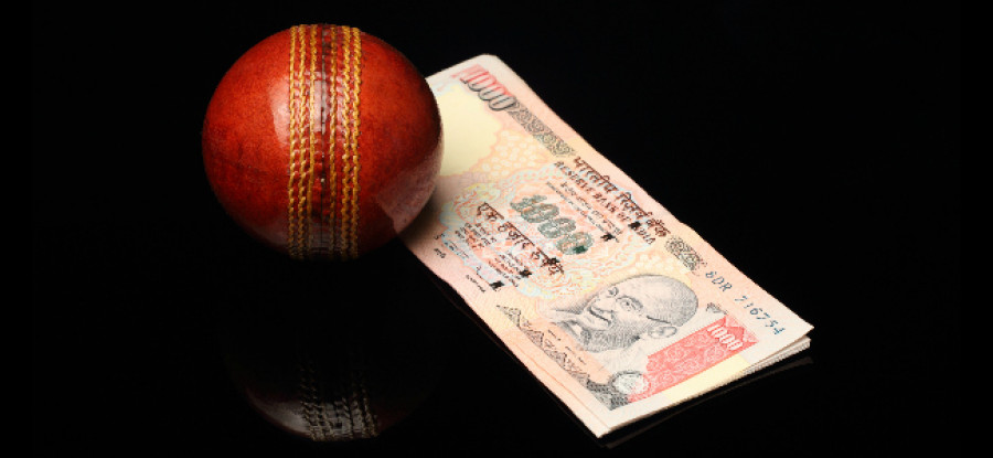 Cricket Ball next to cash