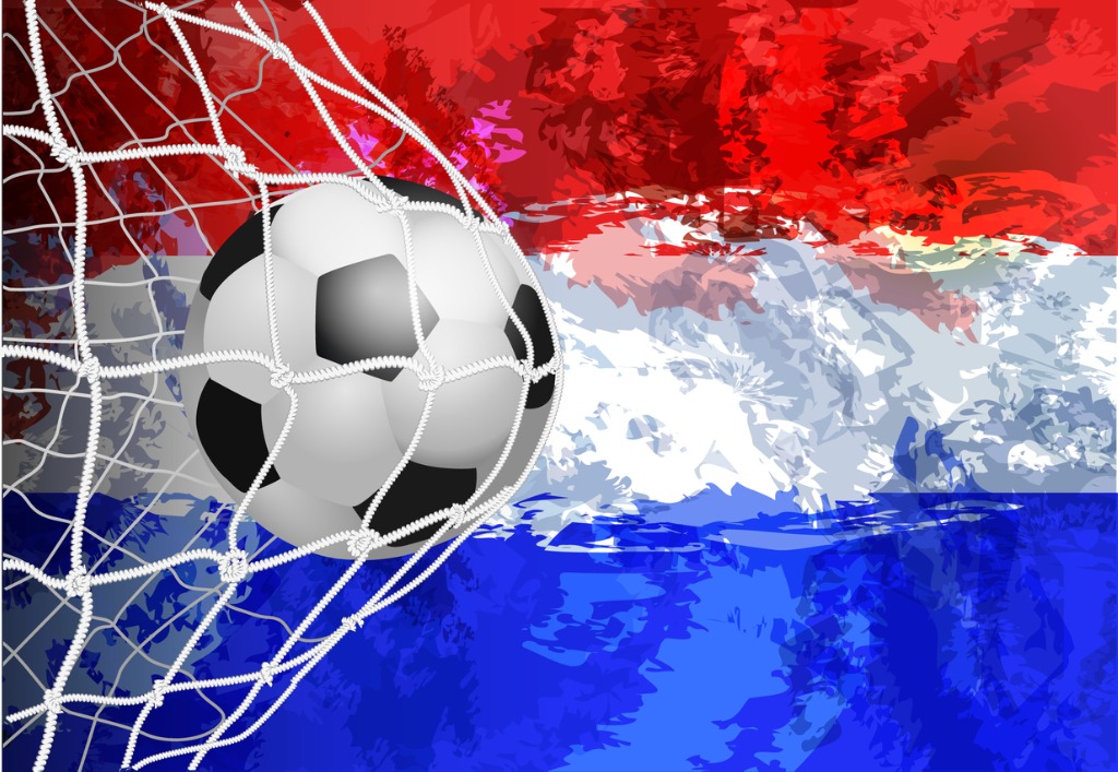 Dutch flag on football hitting back of net