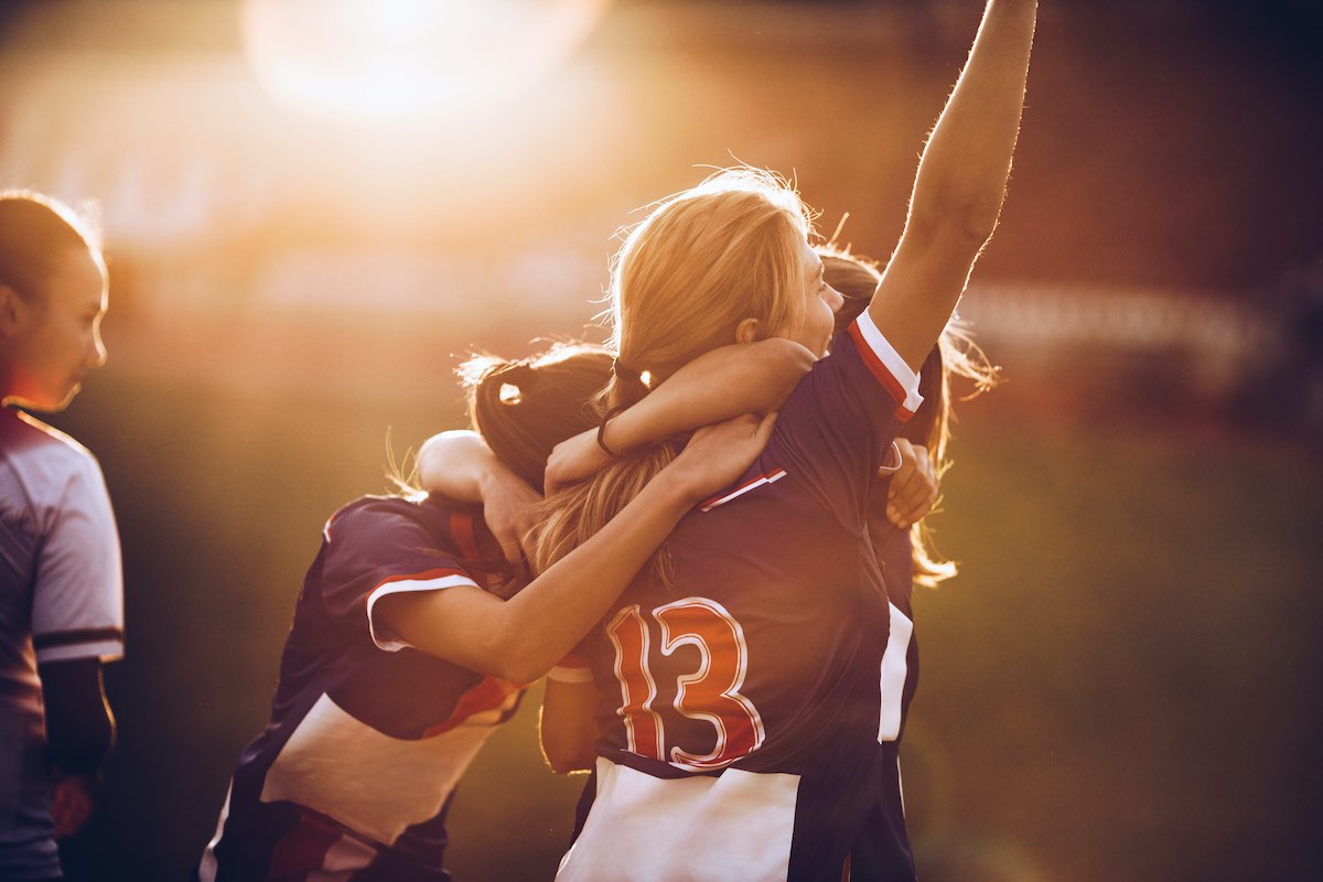 Image of female footballer's celebrating a goal