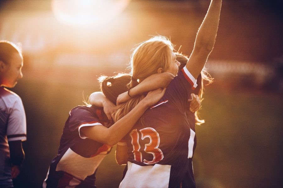 Image of female footballer's celebrating a goal