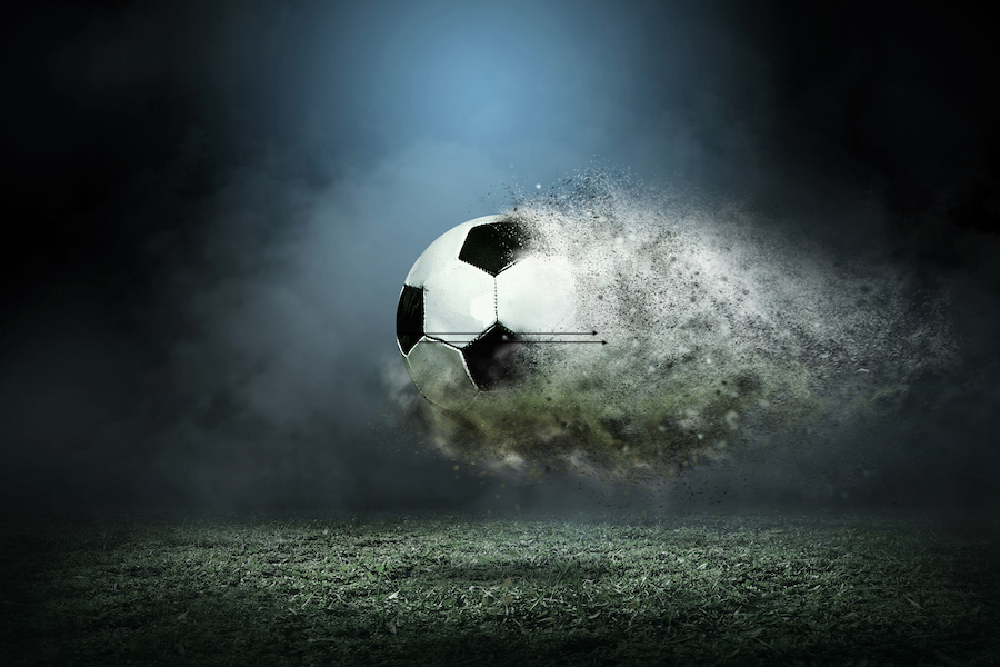 Ball dissolving in air over a football pitch