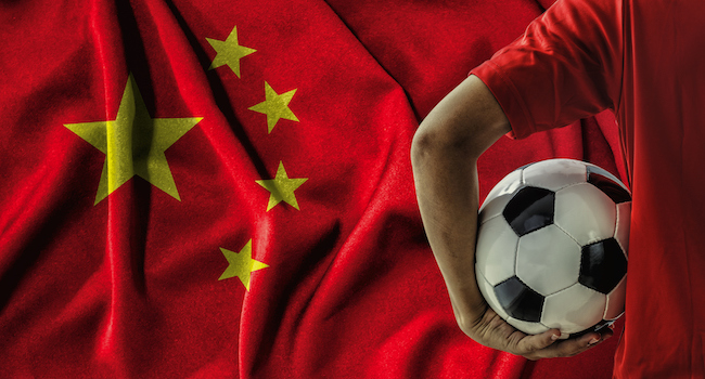 Football player holding football in front on the national flag of China