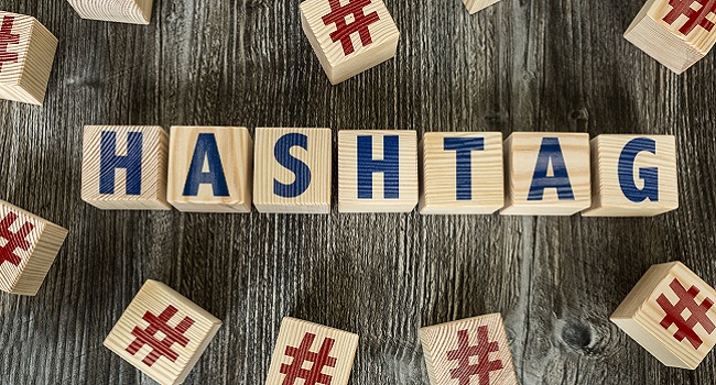 Hashtag text on wooden blocks on top of wooden table