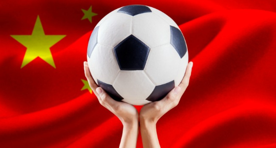 Holding_Football_in_Front_of_Chinese_Flag