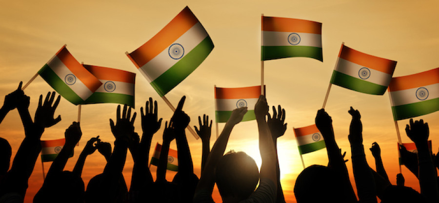 Indian flags waving in front of sunset