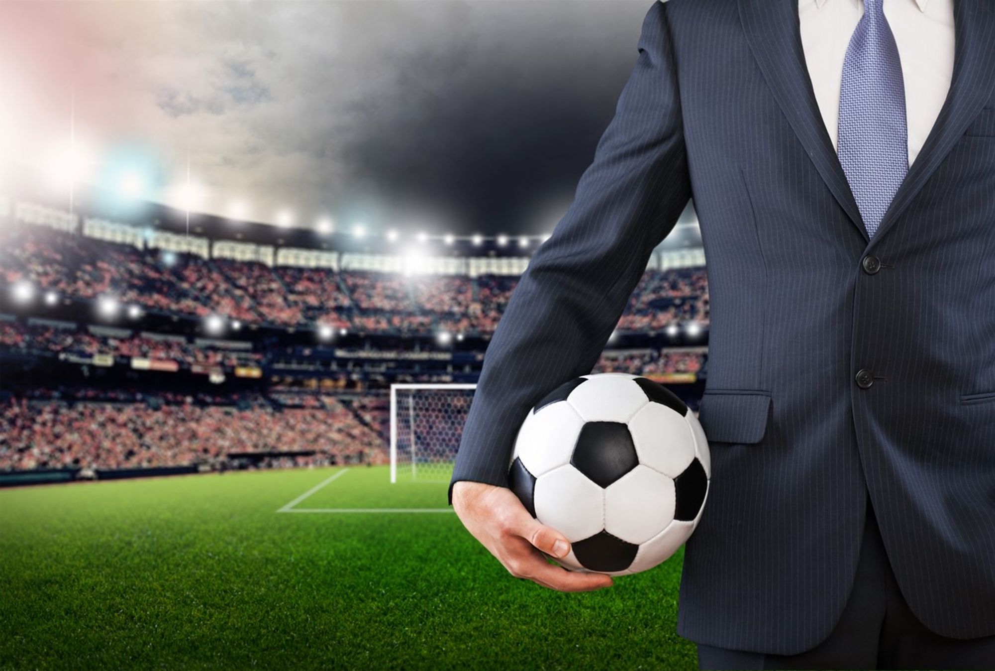 Man in suit holding Football