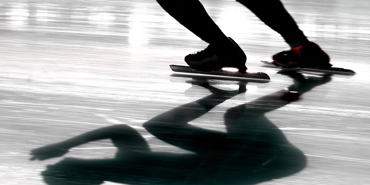 Speedskater with a reflection on ice