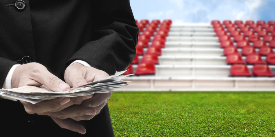 Man holding money on sports field