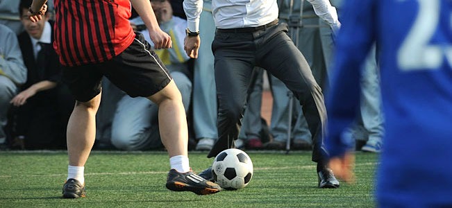 Youth and Suit playing football