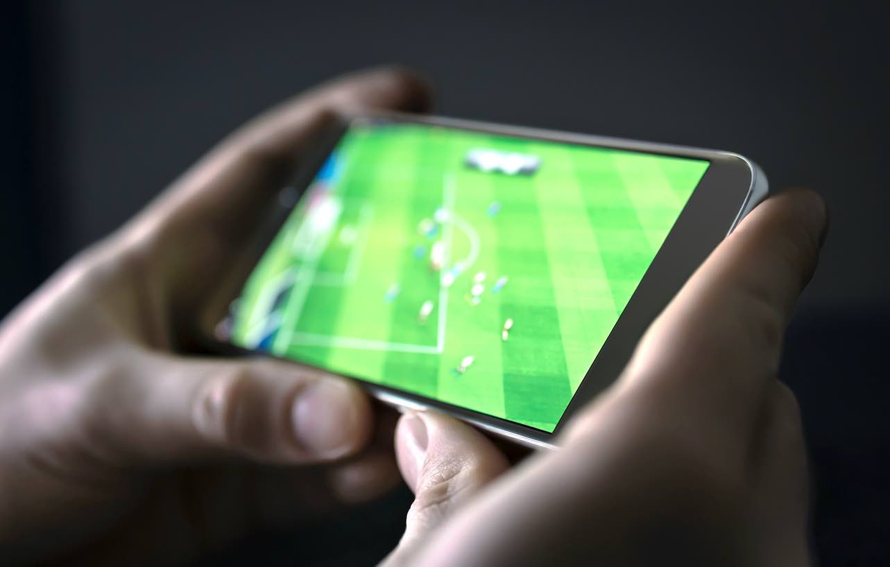 Man watching football on phone