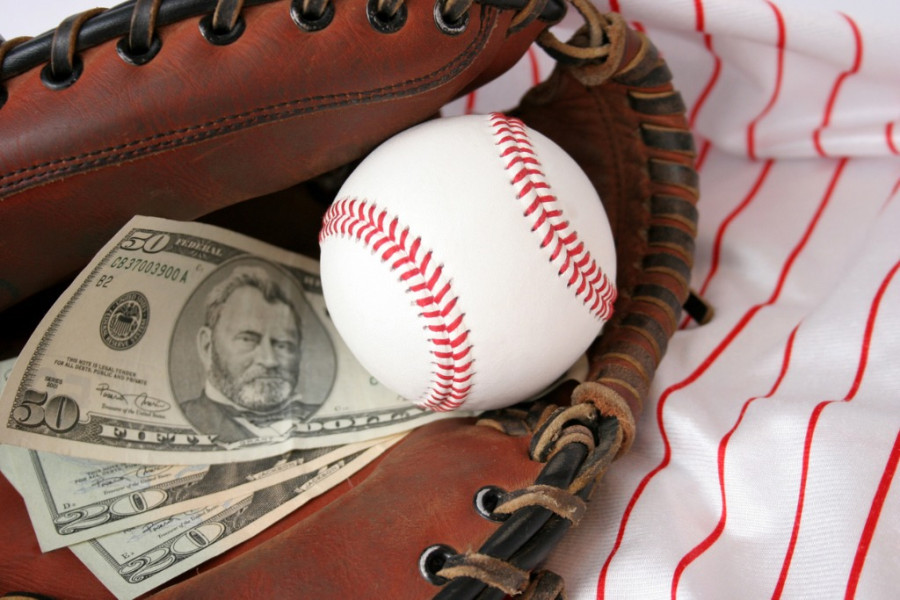 Baseball glove holding a ball and cash