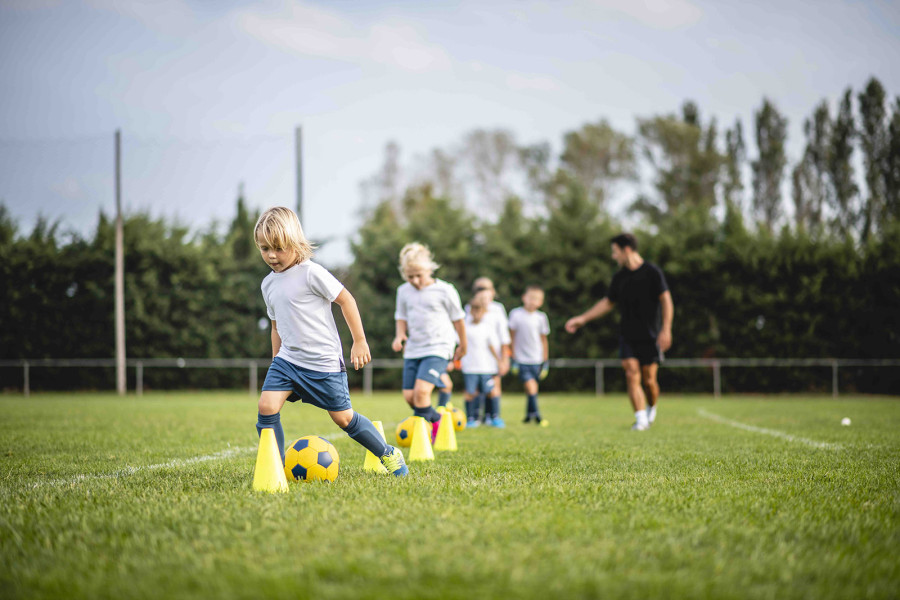 Children Dribbling Football