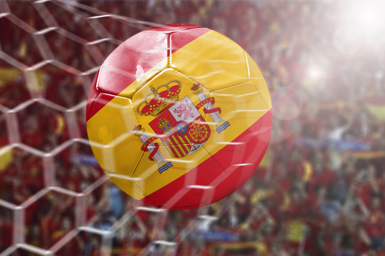 Football with Spain flag in net