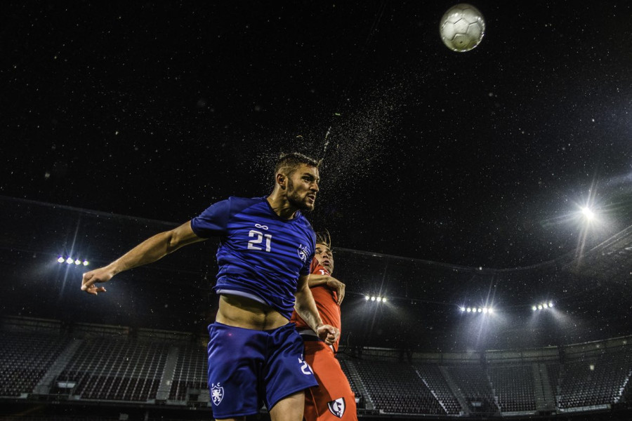 Footballer heading Football