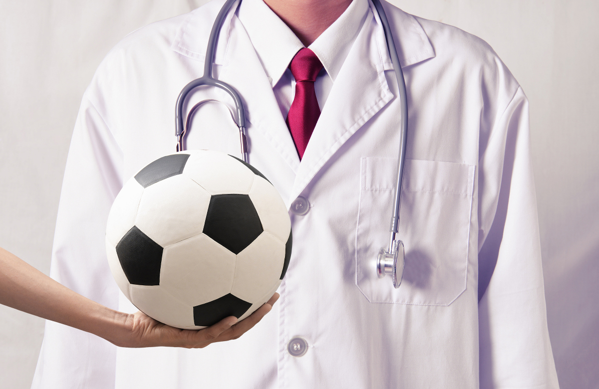 Football in front of white coat