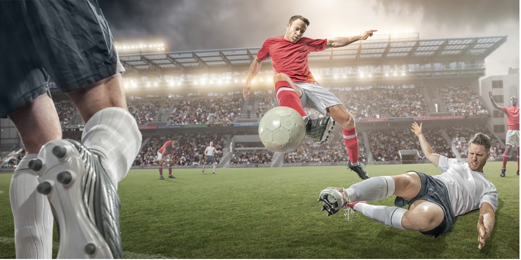 Title image - Football player kicking the ball past a defender