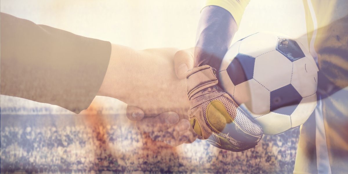 Football goalkeeper on handshake background